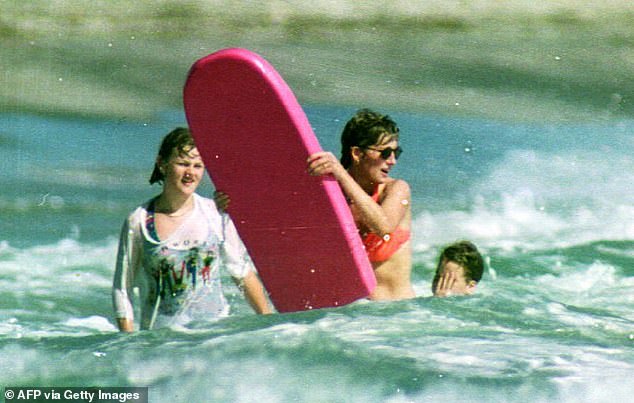 The princess tries to catch a wave with her bright pink board in Nevis