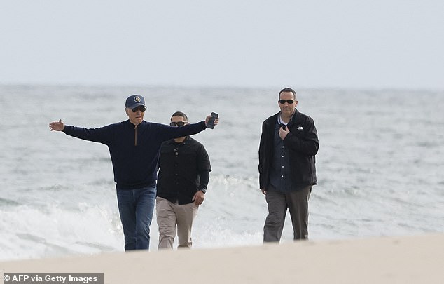 Biden gestures as he walks on the beach at Gordons Pond in Rehoth Beach, Delaware, on November 10