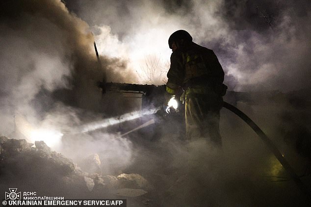 A rescue worker works early Monday morning at the scene of a Russian night attack in Mykolaiv, Ukraine