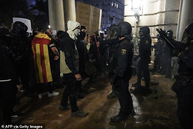 Protesters confront police in front of the city hall during a demonstration to demand the resignation of Valencia Regional President Carlos Mazon in Valencia on November 9, 2024