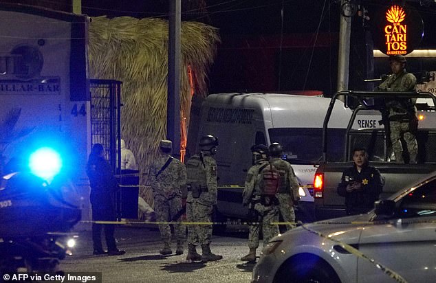 Mexican army soldiers pictured outside the Los Cantaritos bar yesterday