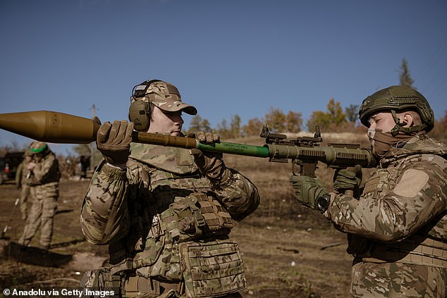 Soldiers and the commander learn how to use an RPG launcher during a training of the drone unit of the 24th Brigade of the Ukrainian Armed Forces on shooting with various weapons, medical evacuations and deployment of tactical medicine in the Donetsk region, Ukraine on 26 October 2024