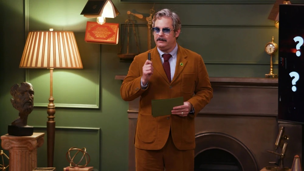 Paul F. Tompkins holds up a pen with index cards in his hands during his presentation in Smartypants