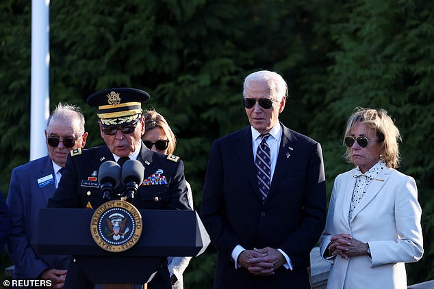 President Joe Biden (center right) stands next to his sister Valerie Biden (right) at a plague dedication for the late Beau Biden to mark Veterans Day on Monday