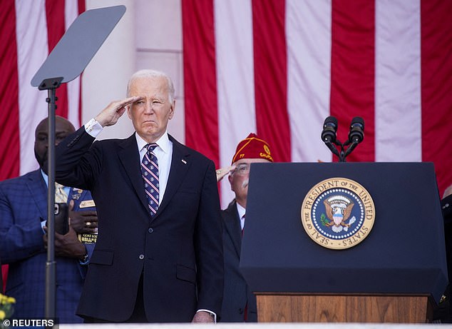 President Joe Biden salutes Monday during the Veterans Day ceremony at Arlington National Cemetery