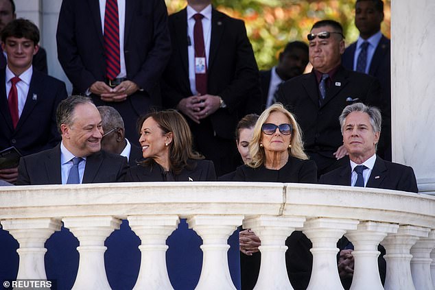 Doug Emhoff and Kamala Harris smile at each other as Jill Biden stares into space