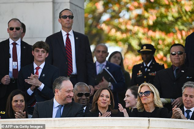 Kamala Harris laughs during the Veterans Day speeches as Doug Emhoff looks on and Jill Biden sits next to her