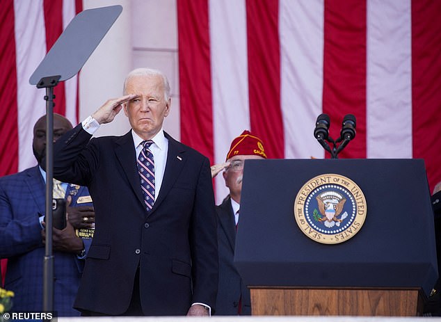 President Joe Biden salutes Monday during the Veterans Day ceremony at Arlington National Cemetery