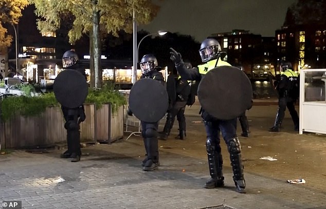 Police in riot gear because the mayor of Amsterdam has banned all demonstrations in the city