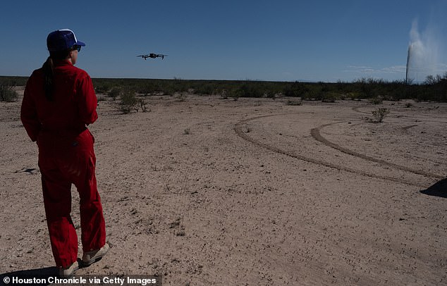 Sarah Stogner uses a drone to capture images and video of a produced water geyser in West Texas as it emerges from the ground in Toyah