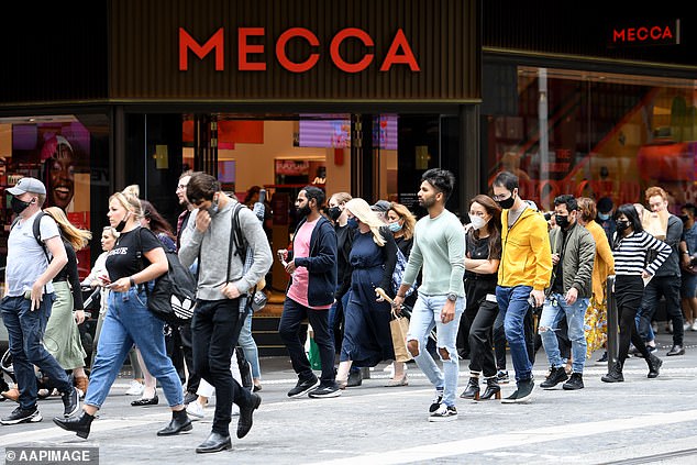 A growing number of Aussies are thinking twice about handing out Christmas presents this year as the cost of living continues to bite (pictured, Sydney shoppers)