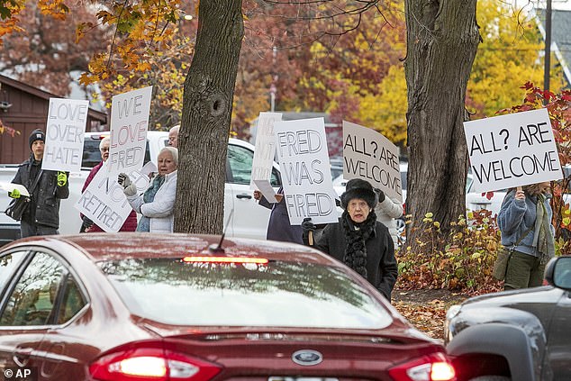 Outraged congregants protested Szczepanski's dismissal on October 27, carrying signs outside the church