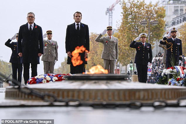 Keir Starmer and Emmanuel Macron stand today in front of the Tomb of the Unknown Soldier on Place de l'Etoile in Paris