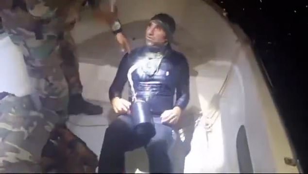 Finally, an officer hoisted the human hidden underneath aboard before handcuffing him