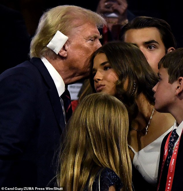 Donald Trump kisses his granddaughter at the RNC after being shot in the ear