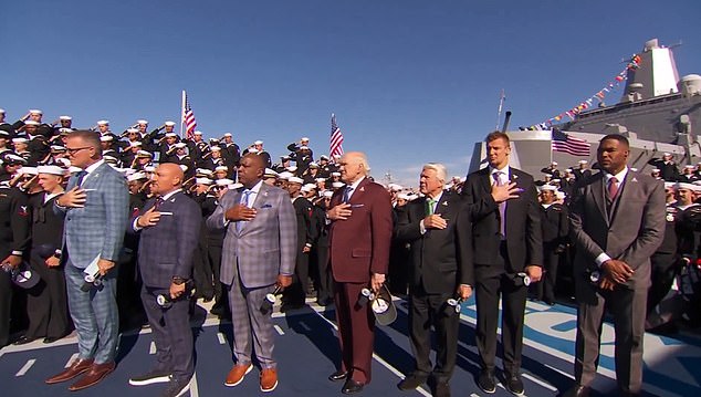 Michael Strahan (right) has been criticized for not placing his hand over his heart during the national anthem on Sunday