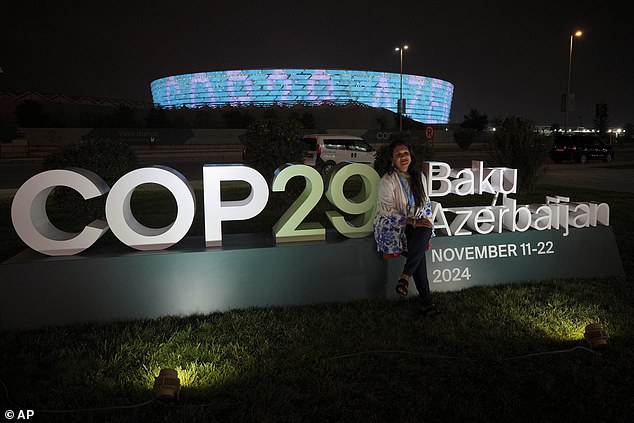 The prime minister is one of the few prime ministers from Azerbaijan's richest countries to attend the annual meeting. In the photo, a female participant poses with the COP29 sign