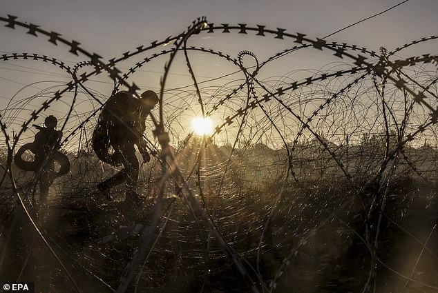 A distribution photo shows Ukrainian soldiers installing anti-tank landmines and non-explosive obstacles along the front line at a secret location near Khasiv Yar, Donetsk region, eastern Ukraine, on October 30, 2024