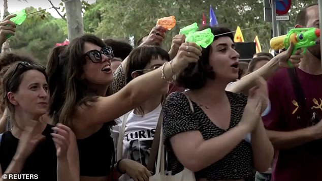 Protesters in Barcelona shot water guns at tourists eating at popular spots in the city