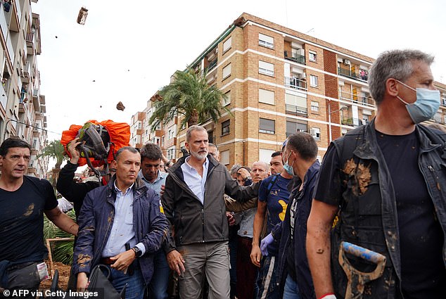 Spain's King Felipe is mobbed and has mud thrown at him by angry locals during a visit to Paiporta in Valencia - where more than 200 people died in devastating floods