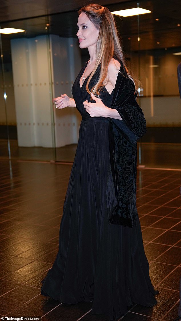 Jolie turned heads in a black, flowy dress with a plunging front neckline and a fitted waist