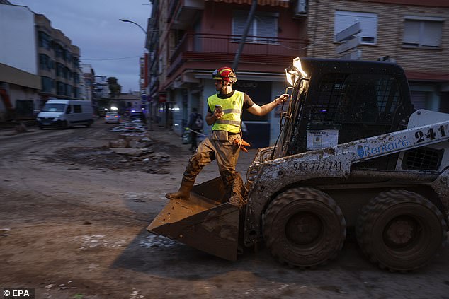 A firefighter helps clean the flood-affected municipality of Paiporta, Valencia province, Spain, November 12, 2024