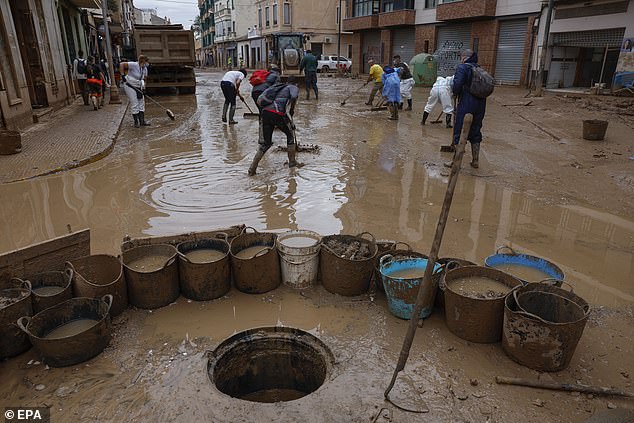 Volunteers help clean the flood-affected municipality of Paiporta, Valencia province, Spain, November 12, 2024