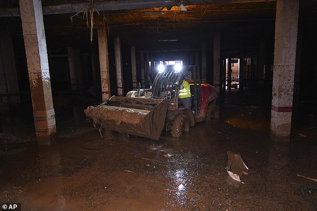 Mud is scooped up after floods in Catarroja left hundreds dead or missing in Spain's Valencia region, Tuesday, November 12, 2024