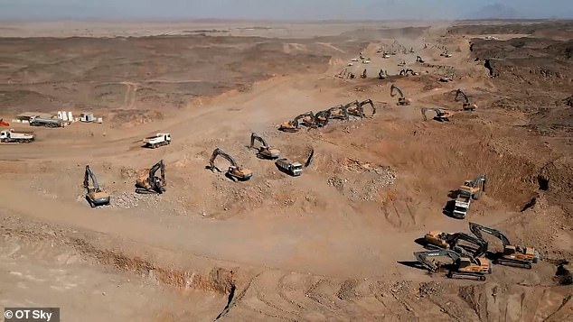 Drone footage taken in 2022 shows construction workers operating excavators