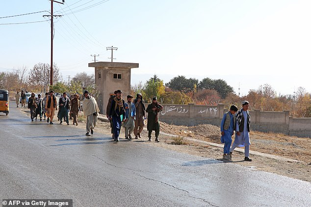 Afghans walk to a football stadium ahead of the public execution of a man by the Taliban in Gardez, Paktia province on November 13, 2024