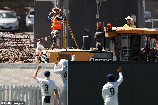 Construction workers at the iconic cricket ground are currently working on a massive $154.7 million redevelopment project (Photo: Construction workers at the WACA pick up a ball during a Sheffield Shield match between Western Australia and New South Wales)