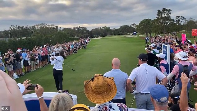 Clark's ball flew off the tee to the left, narrowly avoiding the heads of the fans watching nearby