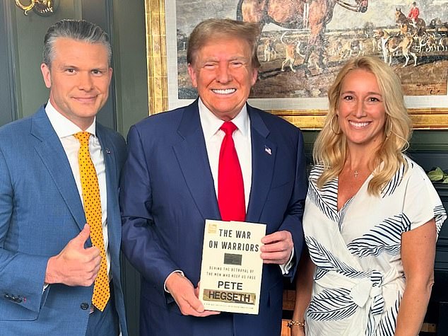 Pete Hegseth poses with President-elect Trump, who holds a copy of the 44-year-old's book