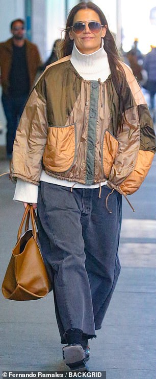 Katie, who has an 18-year-old daughter named Suri Cruise by Tom, modeled voluminous baggy jeans and a bulging leather handbag