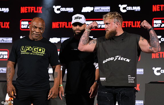 FILE - Mike Tyson, left, and Jake Paul, right, pose for photos during a press conference promoting their upcoming boxing fight, Thursday, May 16, 2024, in Arlington, Texas. (AP Photo/Sam Hodde, File)