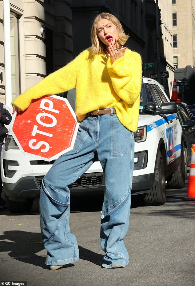 The supermodel, 29, posed in and around a yellow taxi in jeans and a bright yellow sweater