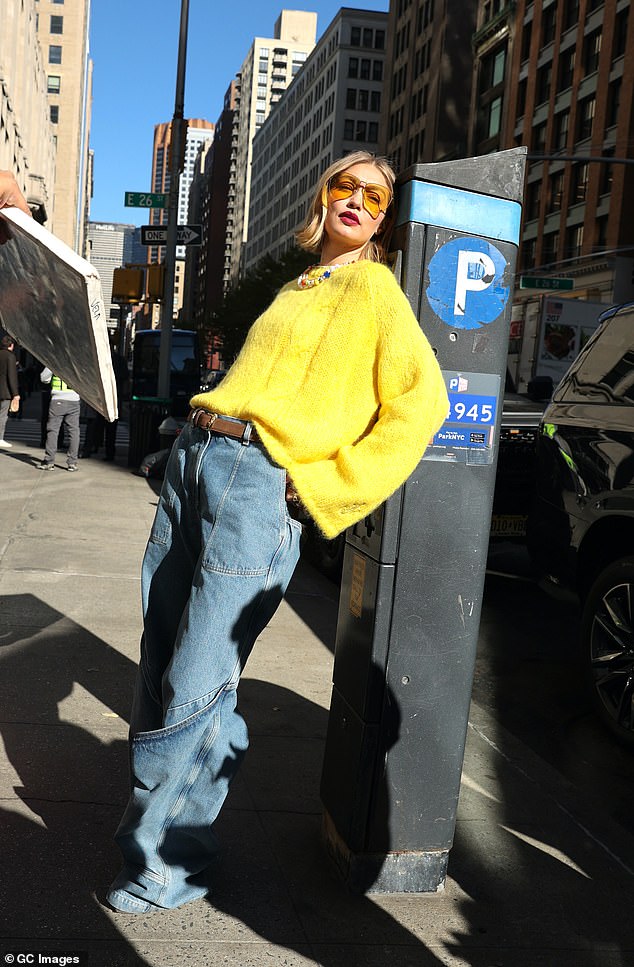 Gigi was also spotted looking sultry with a white rose, clowning with a stop sign and sitting on the hood of a taxi