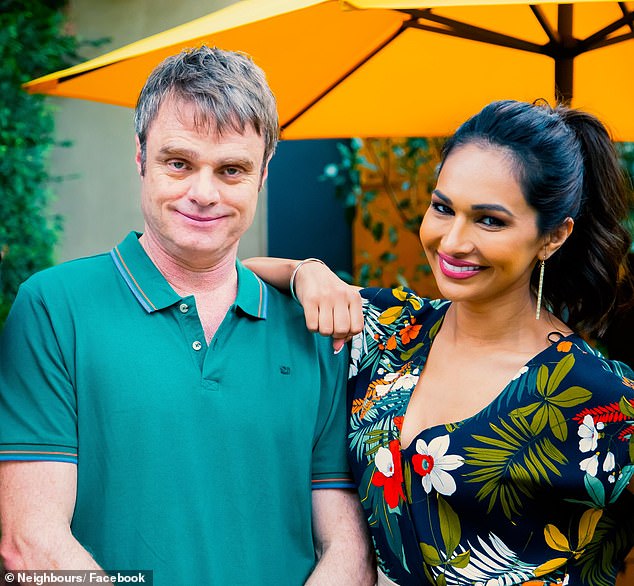 Damien Richardson (left) is pictured with Neighbors co-star Sharon Johal (right) on the set of the soap opera