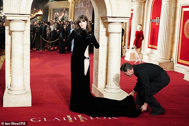 Her dress also had a dramatic long train, which Pedro lovingly fixed for her as she walked down the carpet