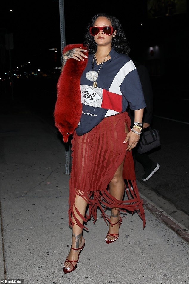 She paired her daring skirt with a navy blue nautical Martine Rose T-shirt that read 