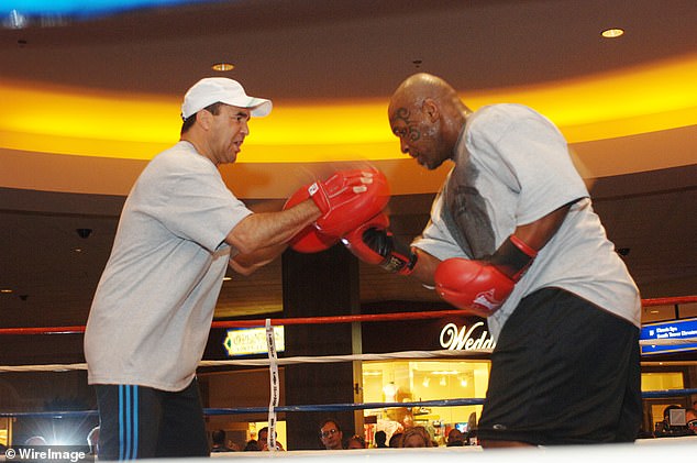 Fenech is seen training Mike Tyson for a fight in March 2005. The two world champions have been friends for decades.