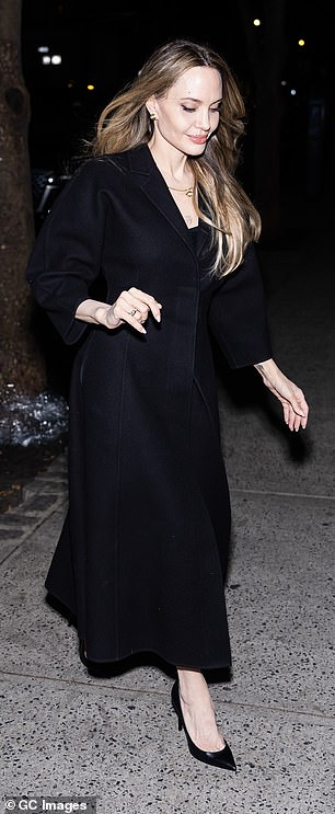 Jolie wore her outerwear over a black outfit, which she completed with a pair of black pointed-toe heels