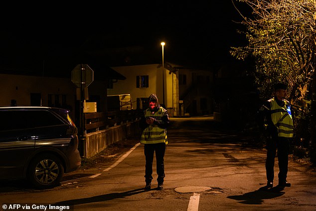 French gendarmes stand guard at the entrance to a street, near the location where three children were found dead, in Taninges, eastern France, on November 12, 2024