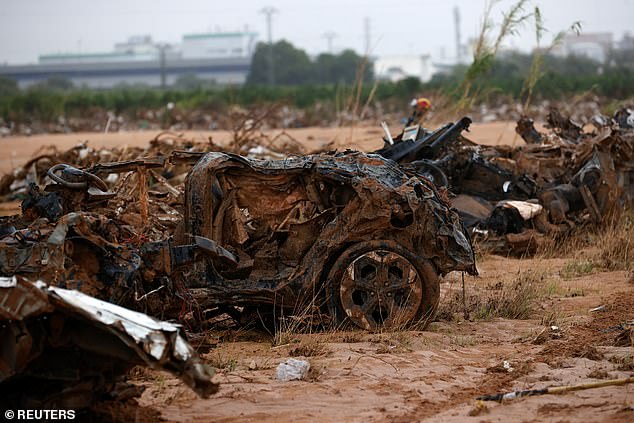 Cars destroyed by the effects of rain are pictured in the Barranco del Poyo in Quart de Poblet, Valencia