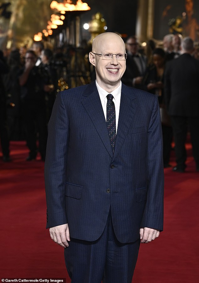 He wore his suit over a crisp white shirt and a thin navy blue tie with a fun multi-colored square design