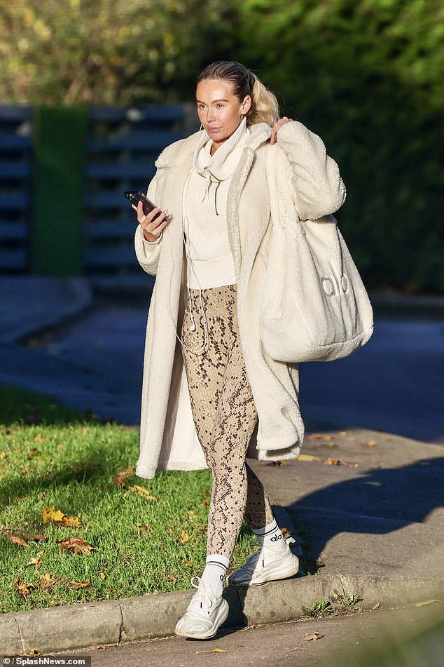 The former Miss Sweden cut a sporty figure in a white zip-up sweater and brown snakeskin print leggings