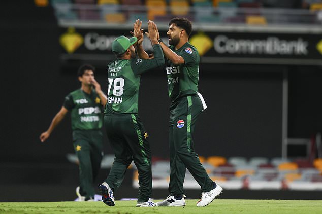 Pakistan's Haris Rauf and Usman Khan (left) celebrate the dismissal of Australia's Matt Short during the T20 cricket international between Pakistan and Australia at the Gabba in Brisbane, Australia, Thursday, November 14, 2024. (AP Photo/Tertius Pickard)