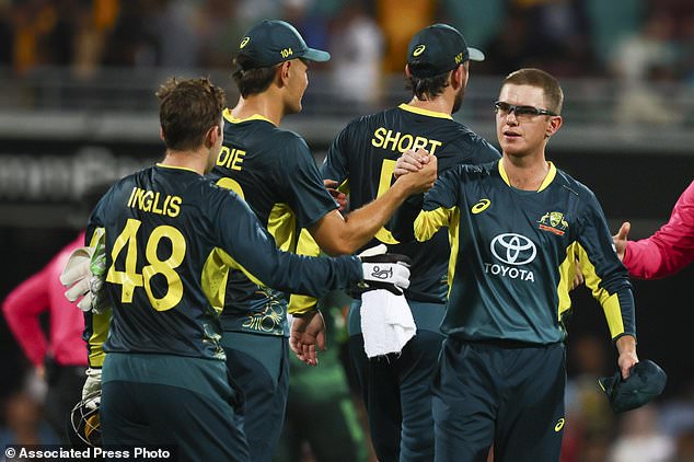 Australian Adam Zampa, right, celebrates with teammates after beating Pakistan during the T20 cricket international between Pakistan and Australia at the Gabba in Brisbane, Australia, Thursday, November 14, 2024. (AP Photo/Tertius Pickard)