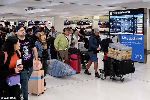 Jetstar, Qantas and Virgin Australia will resume flights to and from Bali on Thursday. Passengers at Sydney International Airport are pictured