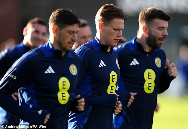 Midfielder McTominay, centre, is joined by Scotland teammates McKenna and Hanley